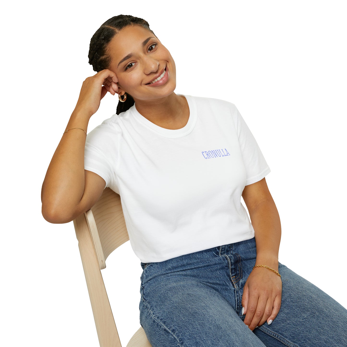 Seated female model wearing grey Cronulla Sunrise 'pocket design' photo t-shirt. Front of design features the word "Cronulla" in white printed in the left front pocket area.