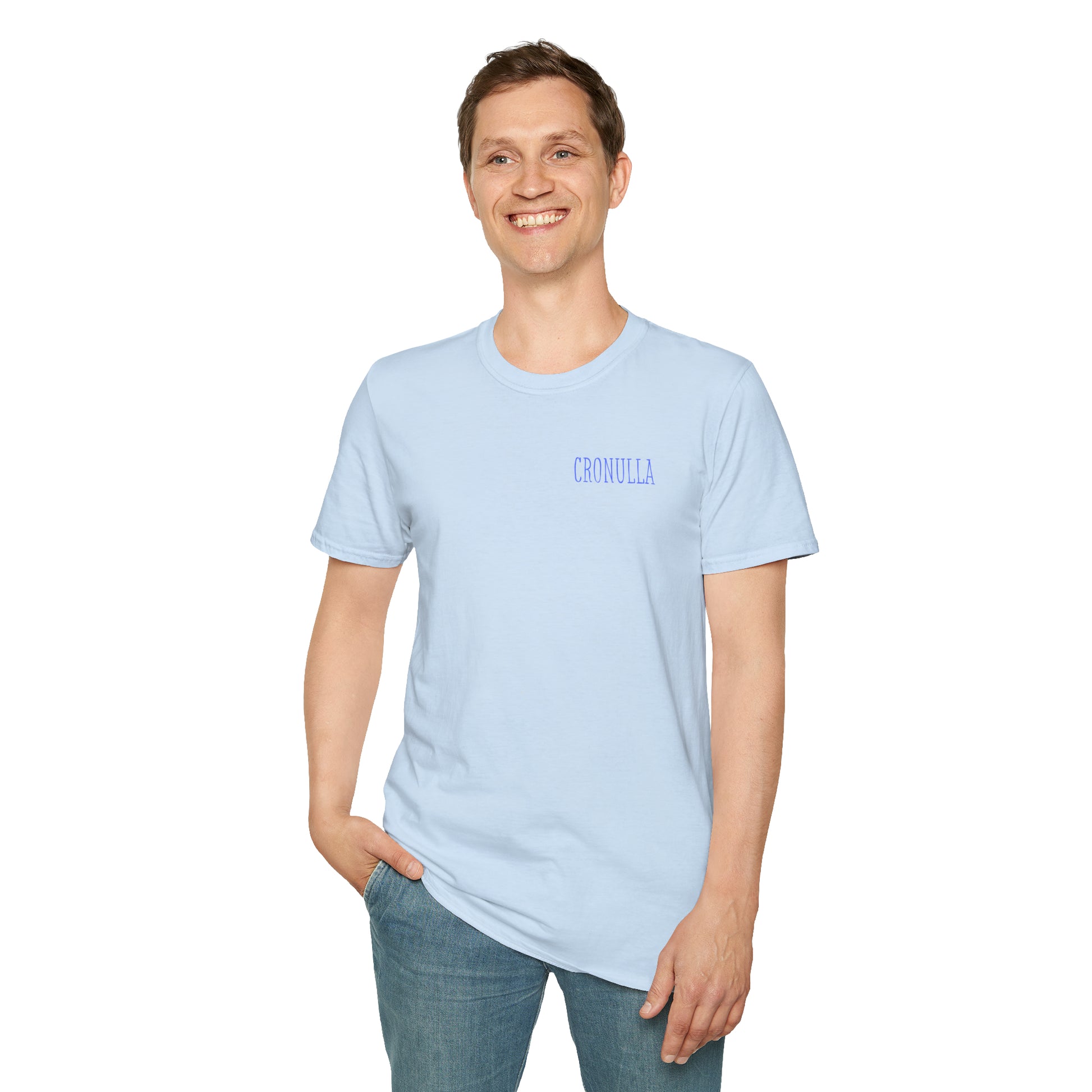 Standing male model wearing pale blue Cronulla Sunrise 'pocket design' photo t-shirt. Front of design features the word "Cronulla" in blue printed in the left front pocket area.